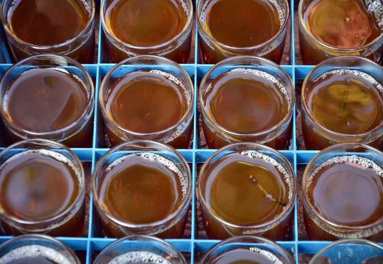 Close-up of tea glasses in crate