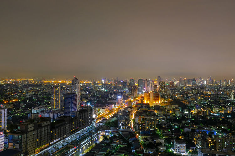 High angle view of illuminated city buildings at night