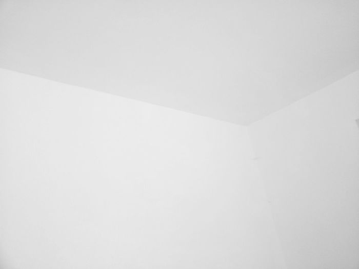 Low angle view of white wall