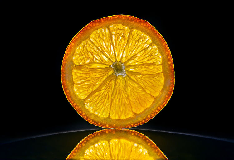 Close-up of lemon slice against black background