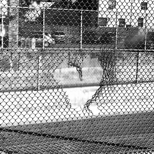 Close-up of heart shape on chainlink fence