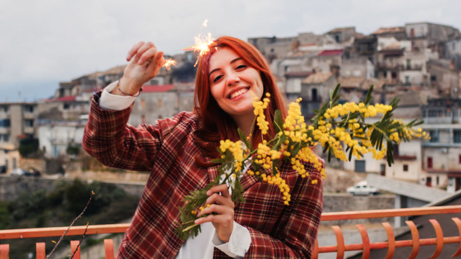 Young beautiful italian girl celebrates women's day with sparkling and mimosa