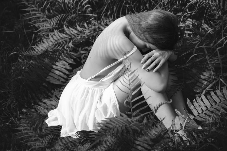 High angle view of woman sitting amidst plants