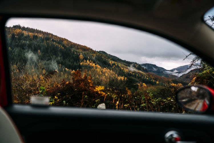Mountain seen through car window during autumn