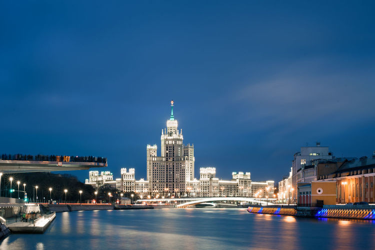 Illuminated city at waterfront