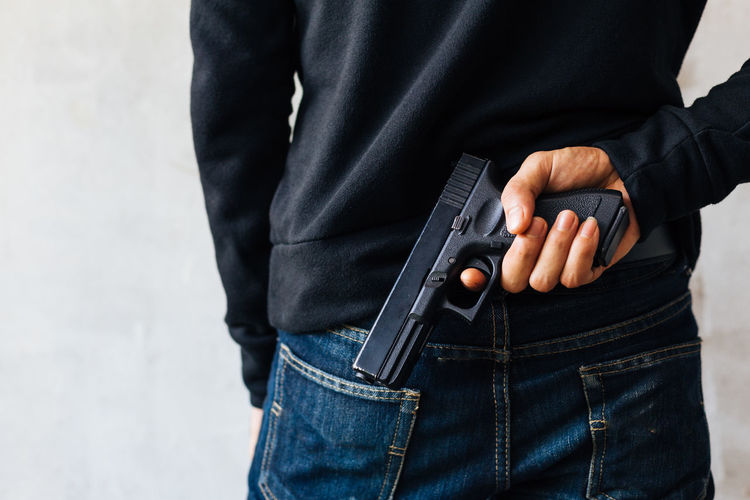 Rear view of man holding handgun