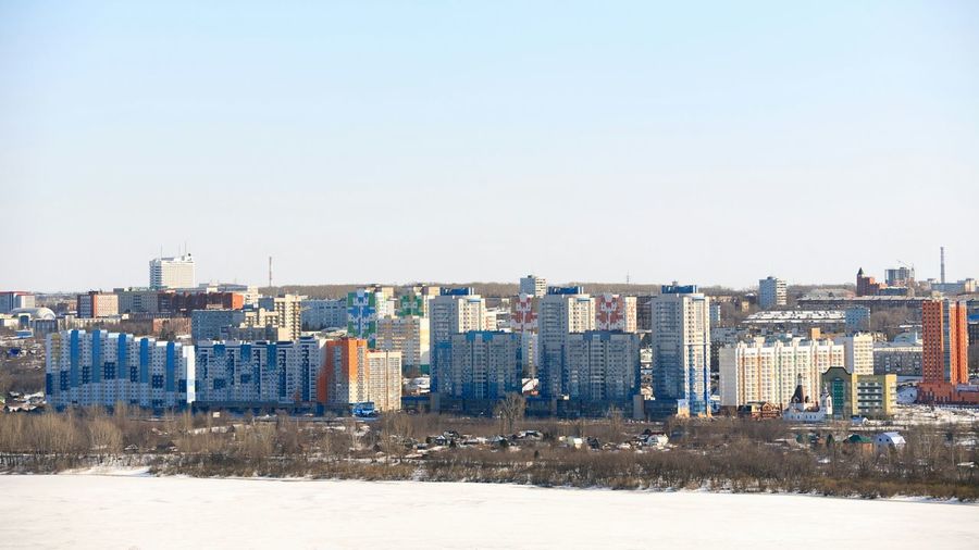Buildings in city against clear sky