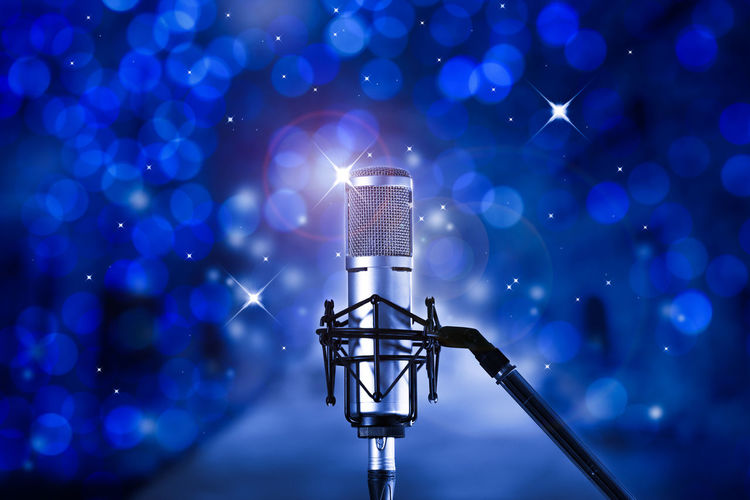 Close-up of microphone against abstract backgrounds