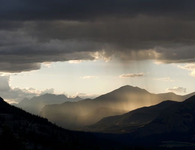 Light at sunset illuminates rain and storm clouds.