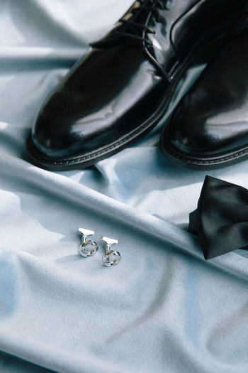 Groom accessories. shoes, bow tie, and cufflinks.