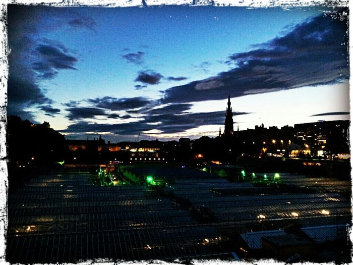 City street against cloudy sky at dusk