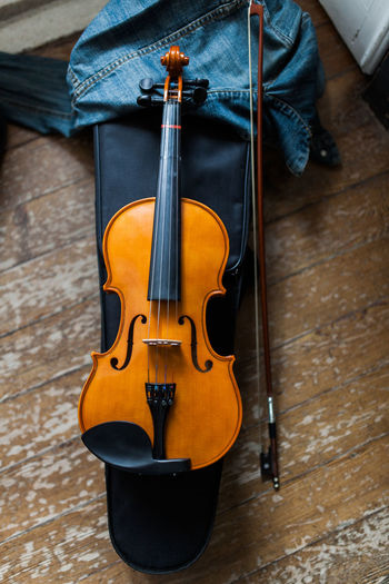 High angle view of violin on wooden table