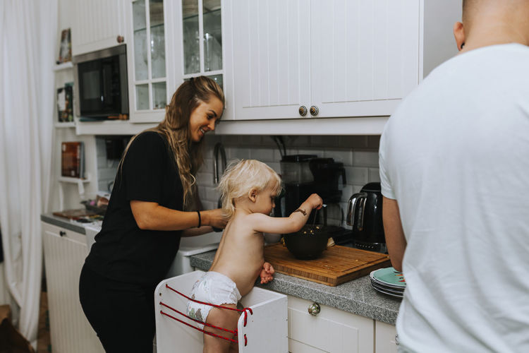 Mother with toddler preparing food
