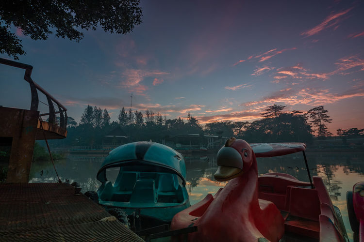 Panoramic view of car against sky at sunset