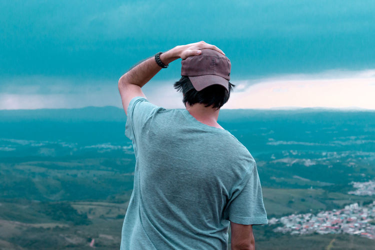 Rear view of man standing against landscape