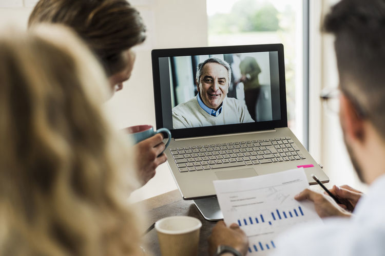 Colleagues having a video conference in office