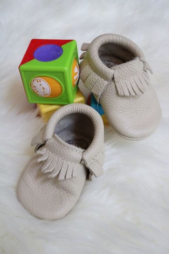 High angle view of baby booties and toys