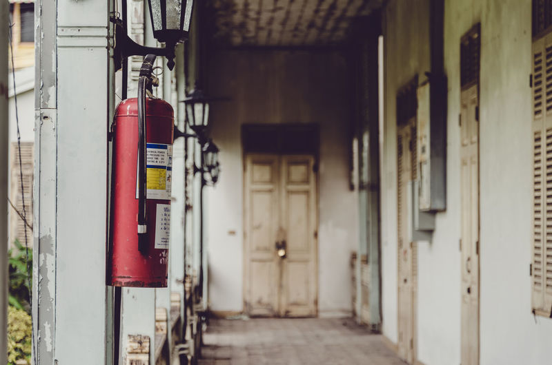 Fire extinguisher hanging in corridor of building
