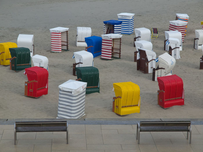 High angle view of hooded chairs on beach
