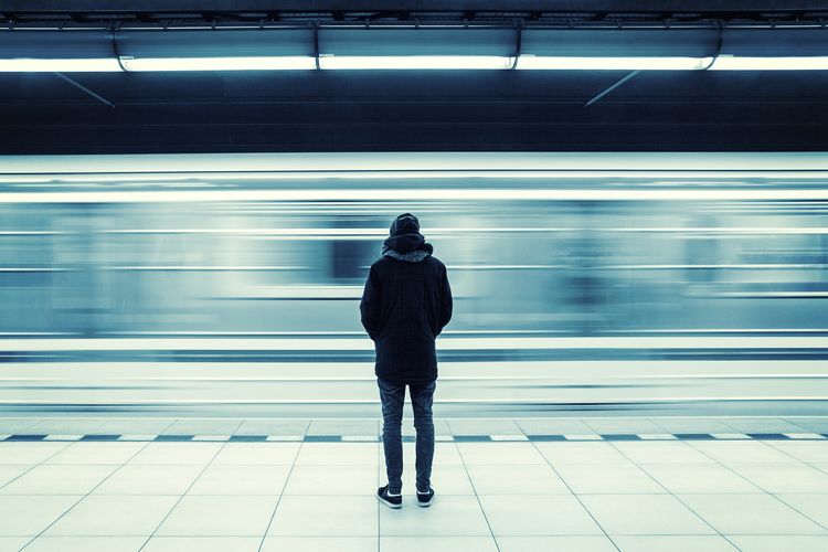 Rear view of man at subway station platform