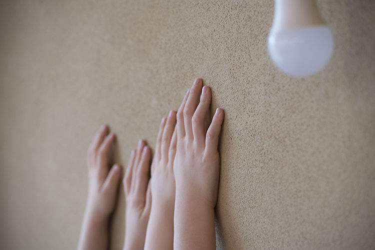 Children touching wall at home