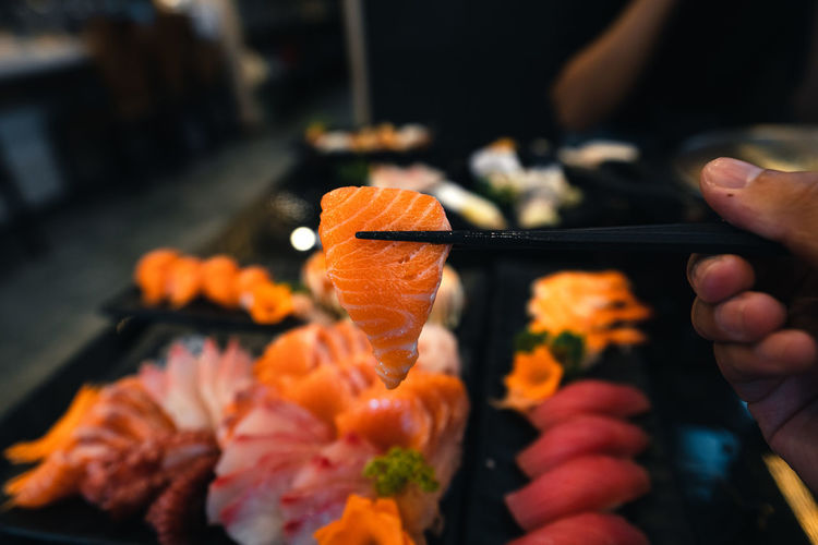 Close-up of hand holding orange