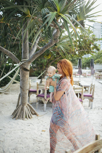 Mother with baby daughter on beach