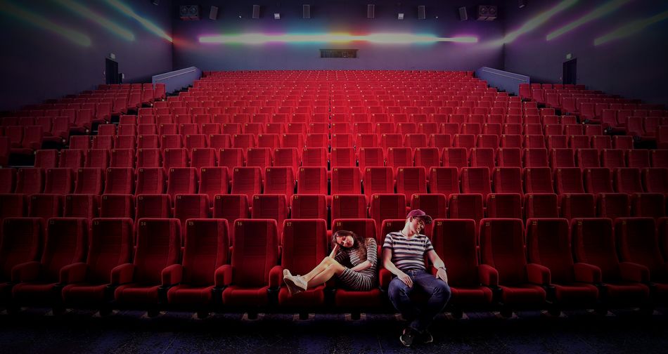 Depressed couple sitting in movie theater