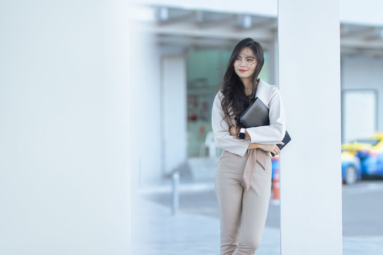 Portrait of young businesswoman standing in office