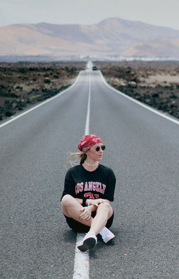 Rear view of man walking on road