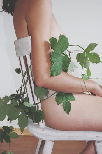 Midsection of woman standing by plant