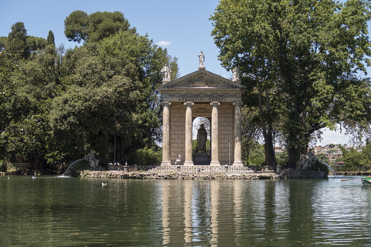 Temple of aesculapius by lake at villa borghese