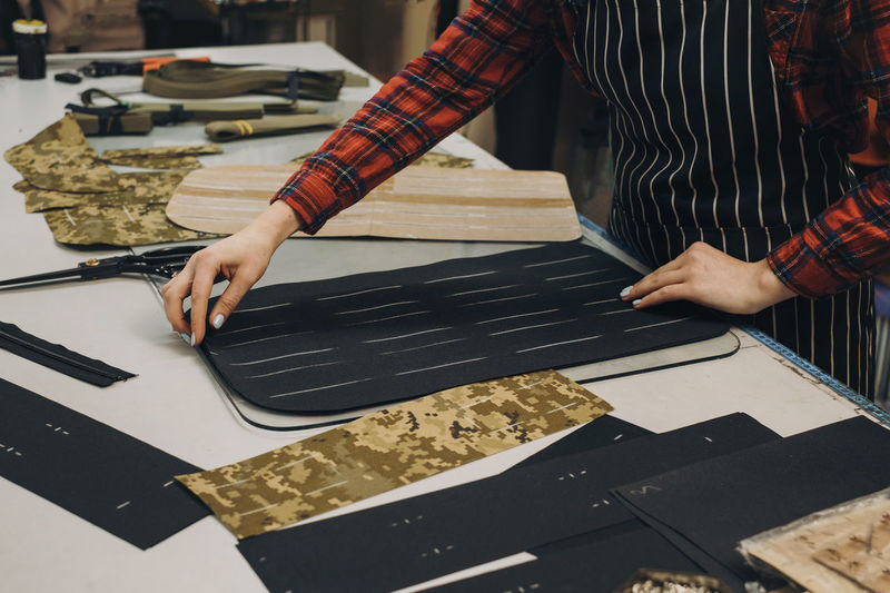 Midsection of man working on table