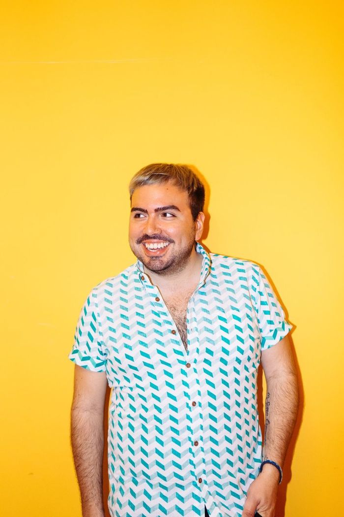 Happy man looking away against yellow background