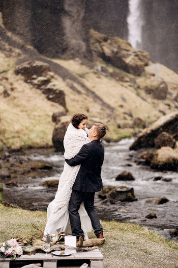 Side view of couple embracing outdoors