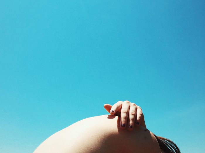 Low angle view of cropped tree against blue sky