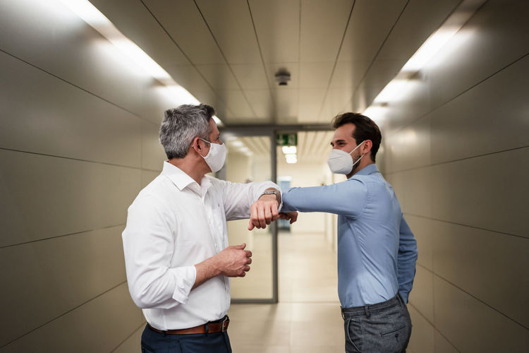 Male entrepreneur doing elbow bump during covid-19