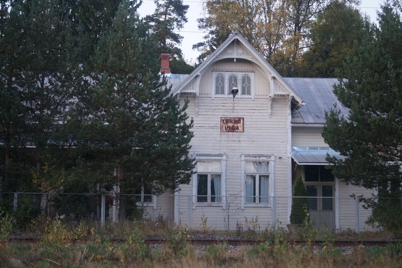 Abandoned building with trees in foreground