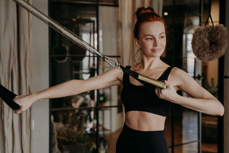Smiling woman exercising at gym