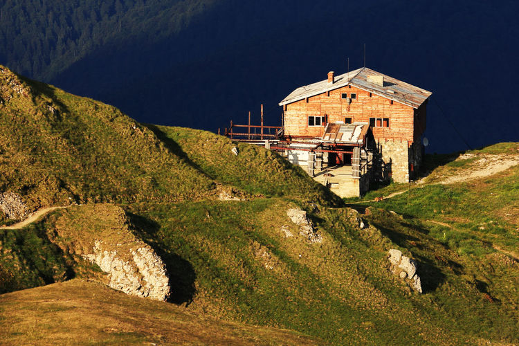 House on mountain at bucegi natural park during sunny day
