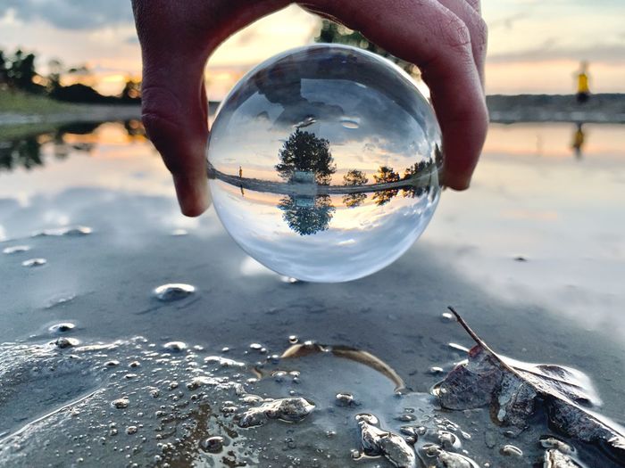 Close-up of hand holding crystal ball