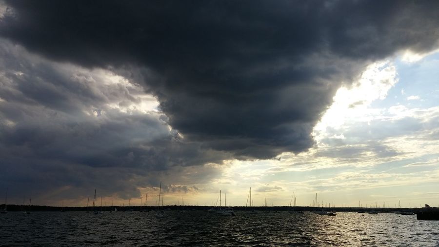 Storm clouds over harbor at sea