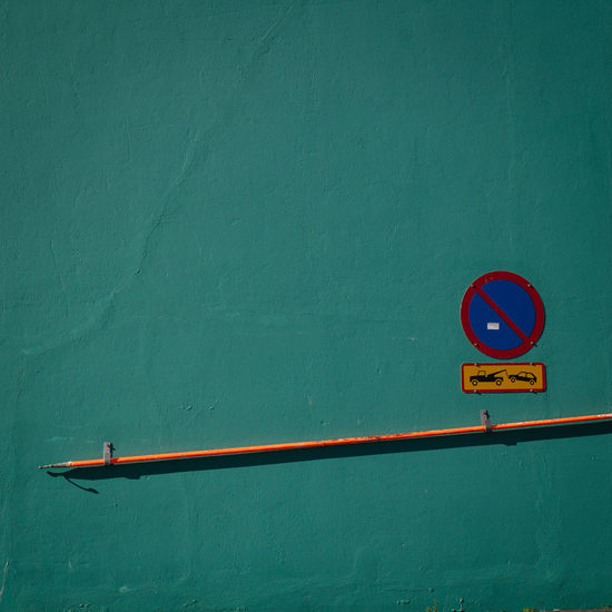 Road sign against blue wall