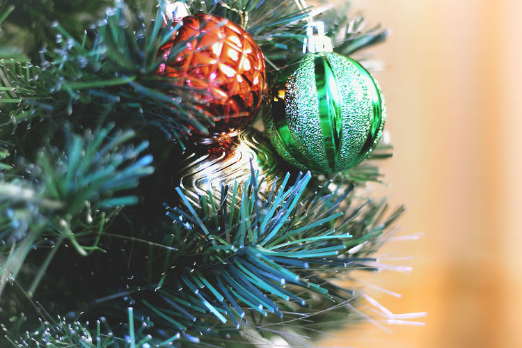 Close-up of christmas ornaments hanging on tree