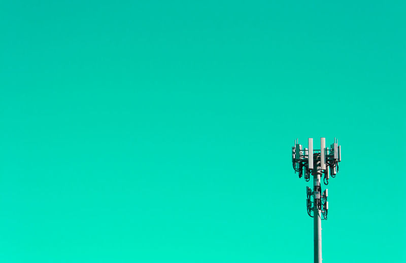 Communications tower against green background