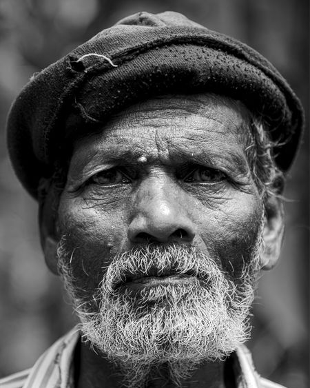 Close-up portrait of mature man wearing hat