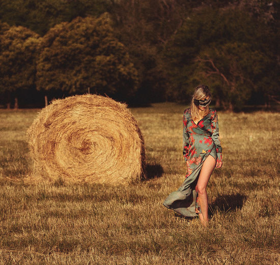 Full length of young woman on field