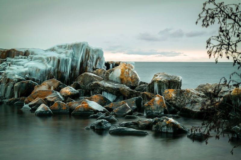Frozen rocks in sea during winter