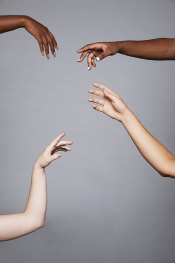 Low angle view of hands of woman against white background