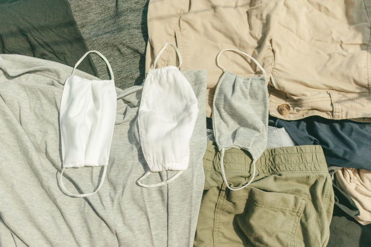 Hygienic mask and clothes being dried on hot sun to kill virus.